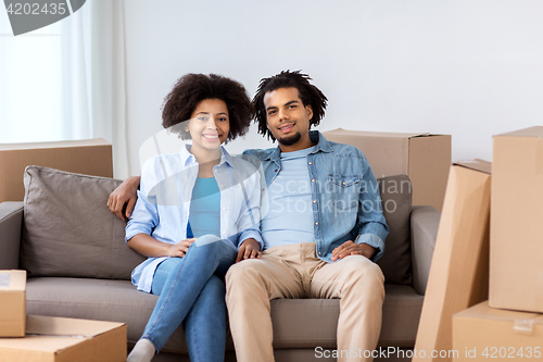 Image of happy couple with boxes moving to new home