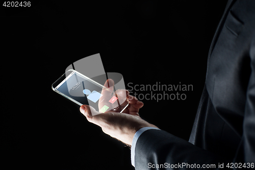 Image of close up of hand with incoming call on smartphone