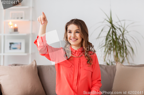 Image of happy woman playing virtual reality game at home