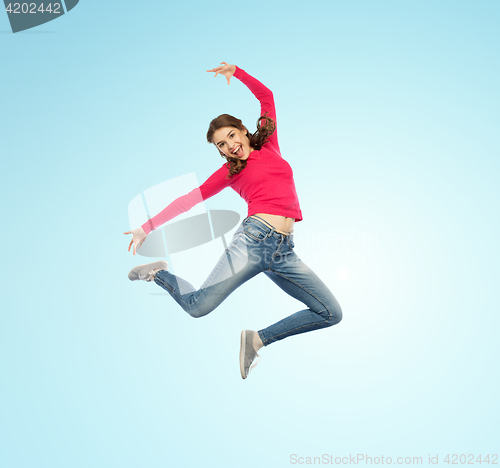 Image of happy young woman jumping in air or dancing