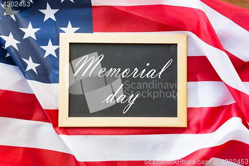Image of memorial day words on chalkboard and american flag