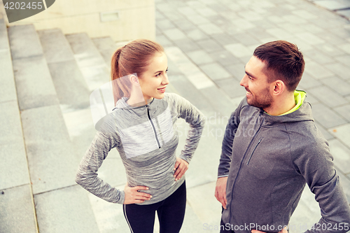 Image of smiling couple outdoors on city street