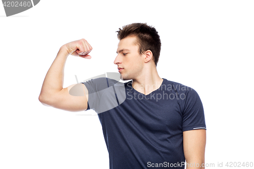 Image of sportive man showing bicep power