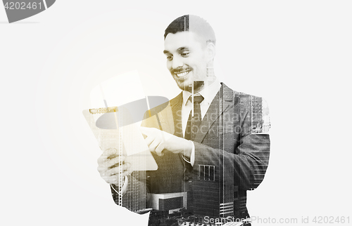 Image of businessman in suit working with tablet pc