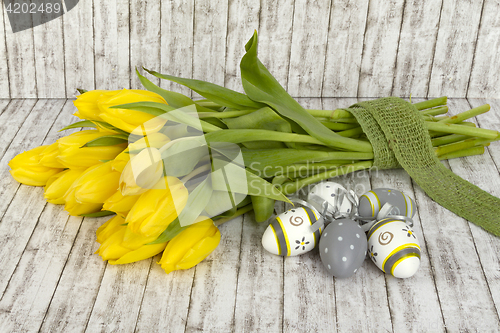 Image of Beautiful yellow tulips with easter eggs