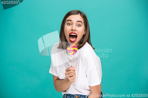 Image of The young woman with colorful lollipop