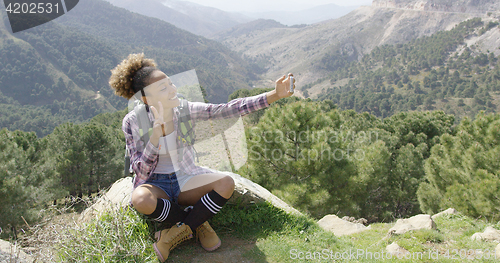 Image of Youg sportive backpacker taking selfie