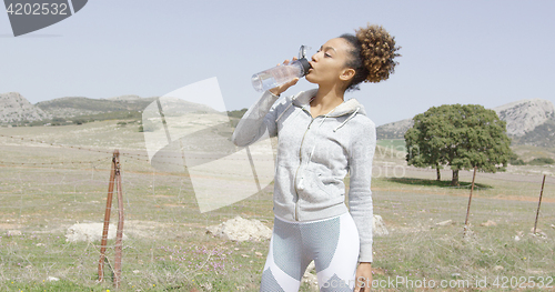 Image of Female drinking water on workout