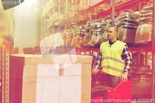 Image of man on forklift loading cargo at warehouse