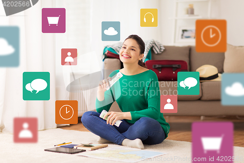 Image of happy woman with money and travel map at home