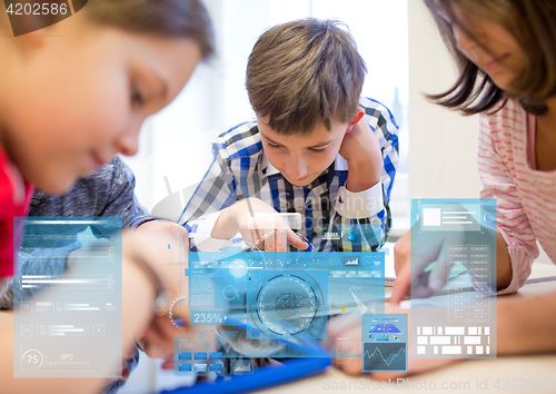 Image of group of school kids with tablet pc in classroom