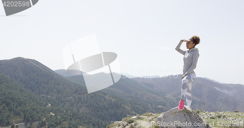 Image of Young sportive woman looking around