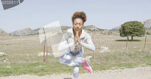 Image of Woman meditating among nature