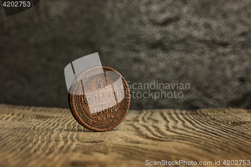 Image of Closeup of old russian coin on a wooden background.