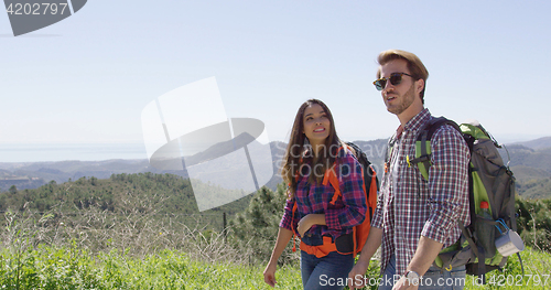 Image of Young couple walking in mountains