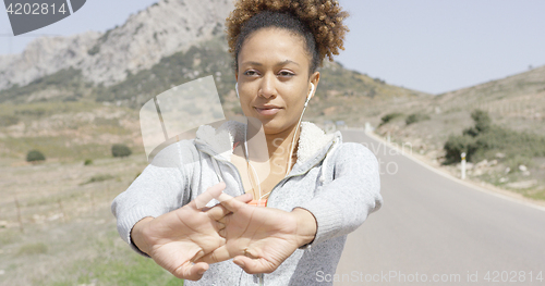 Image of Young delightful female stretching hands