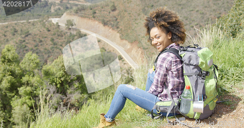 Image of Beautiful female traveler on mountain