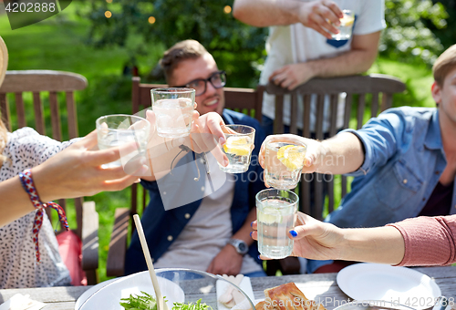 Image of happy friends with drinks at summer garden party