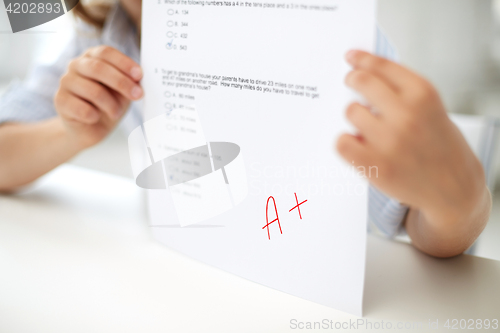 Image of girl with test paper at school