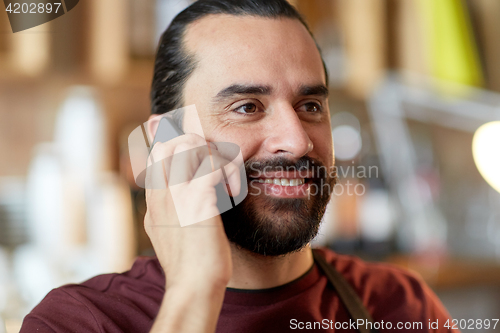 Image of close up of man or waiter calling on smartphone