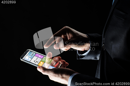 Image of close up of businessman with apps on smartphone