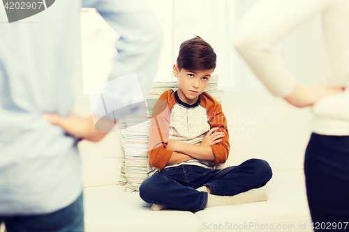 Image of upset or feeling guilty boy and parents at home