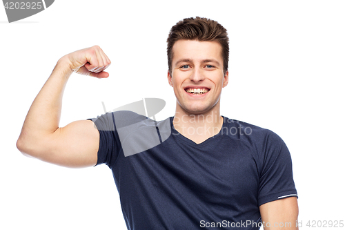 Image of sportive man showing bicep power