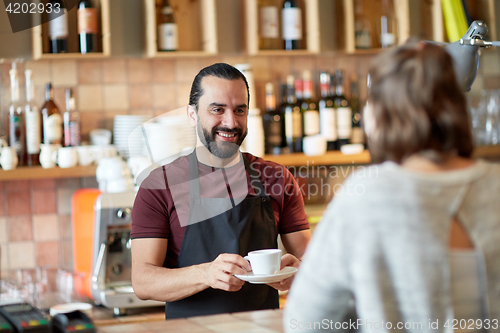 Image of man or waiter serving customer in coffee shop