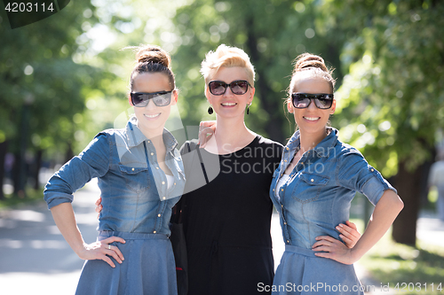 Image of portrait of three young beautiful woman with sunglasses