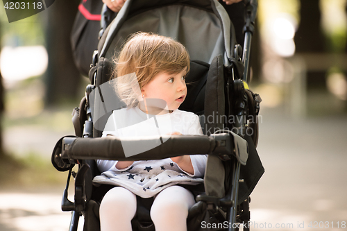 Image of baby girl sitting in the pram