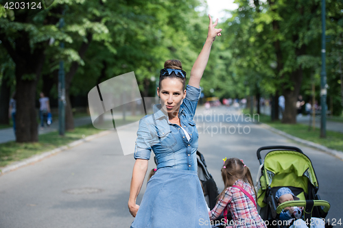 Image of mother with her daughters in the park