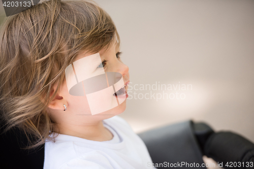 Image of baby girl sitting in the pram