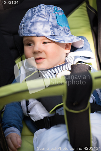 Image of baby boy sitting in the pram
