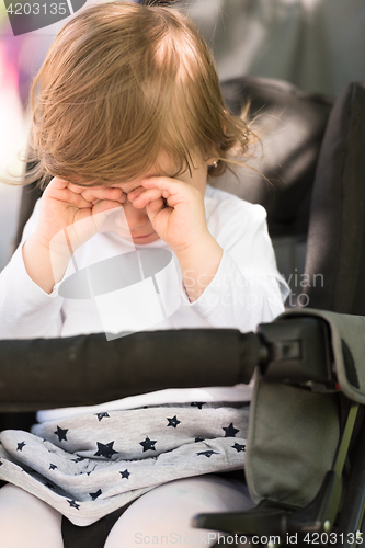 Image of baby girl sitting in the pram