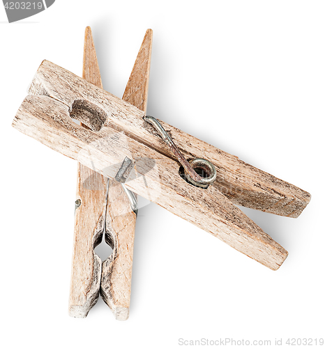 Image of Two old wooden clothespins on each other