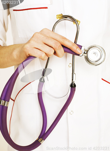 Image of Close-up of female doctor holding stethoscope 