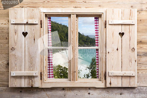 Image of Wooden window with tropical panorama view