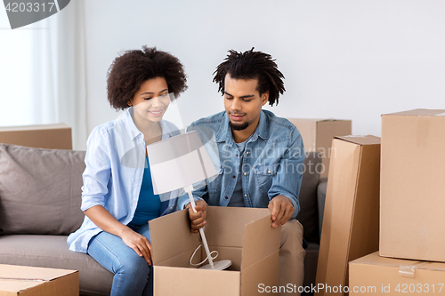 Image of happy couple with stuff moving to new home