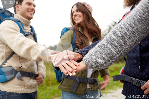 Image of group of happy friends with backpacks hiking