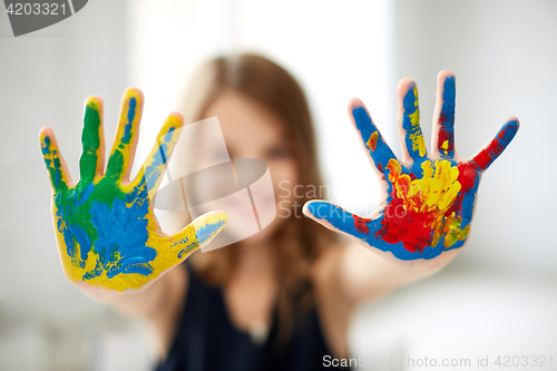 Image of girl showing colored hands