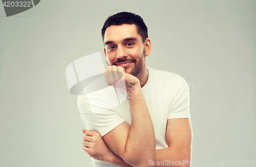 Image of smiling man over gray background