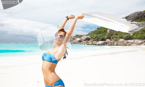 Image of woman in bikini and sunglasses with pareo on beach