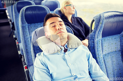 Image of man sleeping in travel bus with cervical pillow