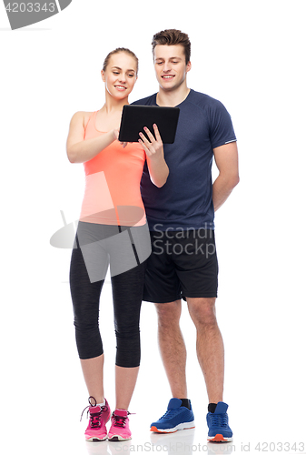 Image of happy sportive man and woman with tablet pc