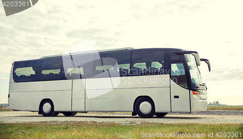 Image of tour bus driving outdoors