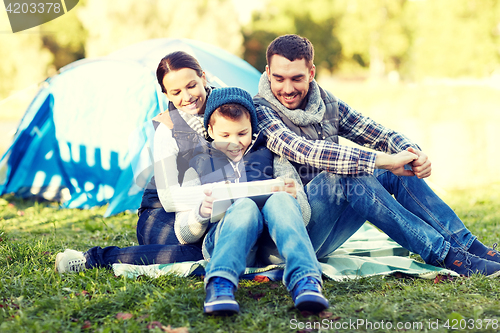 Image of happy family with tablet pc and tent at camp site