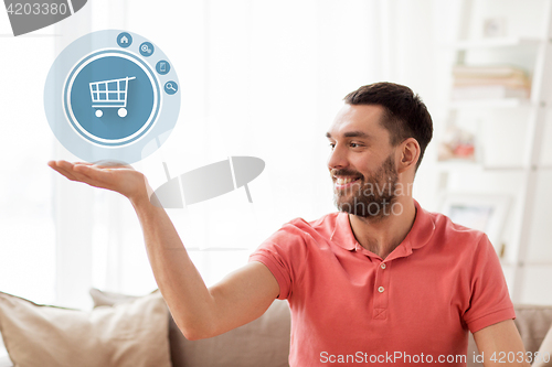 Image of man with shopping cart icon projection at home