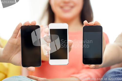 Image of happy women or teenage girls with smartphones