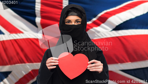 Image of muslim woman in hijab holding red heart