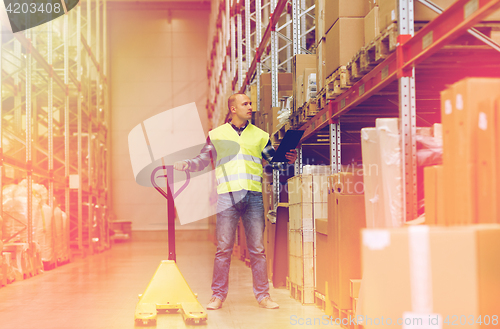 Image of man with loader and clipboard at warehouse